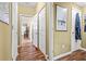 Hallway featuring wood-look floors, white trim, and access to a separate living area at 47 Powder Springs St, Hiram, GA 30141