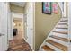 Inviting hallway featuring warm paint, white trim, and beautiful wood-look floors leading to a living area at 47 Powder Springs St, Hiram, GA 30141