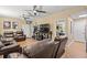Spacious living room with comfortable leather furniture, ceiling fans, and plenty of natural light at 47 Powder Springs St, Hiram, GA 30141