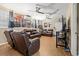 Spacious living room with reclining leather furniture, movie posters and dual ceiling fans at 47 Powder Springs St, Hiram, GA 30141