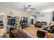 Spacious living room with reclining leather furniture, ceiling fans, TV and laminate floors at 47 Powder Springs St, Hiram, GA 30141