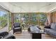 Enclosed porch featuring wicker furniture and string lights, perfect for outdoor entertaining at 47 Powder Springs St, Hiram, GA 30141
