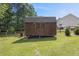 Exterior view of the wooden shed in the backyard, surrounded by a well-maintained grassy area at 47 Powder Springs St, Hiram, GA 30141