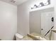 Bright bathroom with granite countertop vanity, toilet, and modern lighting at 625 Compton Ln, Mcdonough, GA 30253