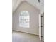 Bedroom with carpet, large arched window, and a closet providing ample storage at 625 Compton Ln, Mcdonough, GA 30253