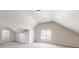 Spacious carpeted bedroom with angled ceilings and ample natural light from windows at 625 Compton Ln, Mcdonough, GA 30253