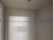 A modest closet is shown with metal shelving and white walls at 625 Compton Ln, Mcdonough, GA 30253