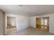 Open-concept living room with carpeting, tiled dining area and staircase at 625 Compton Ln, Mcdonough, GA 30253