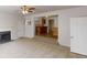 Living room with a modern fireplace and view of the adjacent kitchen area featuring wooden cabinetry at 625 Compton Ln, Mcdonough, GA 30253