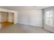 Spacious living room with plush carpeting and a large window at 625 Compton Ln, Mcdonough, GA 30253