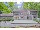 Charming home with a large deck, grey siding, and a beautiful tree-filled backyard at 115 Leaf Lake Dr, Suwanee, GA 30024