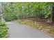 Seating area in backyard with trees and a gravel terrace at 115 Leaf Lake Dr, Suwanee, GA 30024