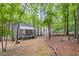 Backyard featuring a wooden deck area with surrounding trees at 115 Leaf Lake Dr, Suwanee, GA 30024