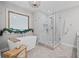 Bright bathroom featuring a soaking tub, shower, and herringbone-patterned tile flooring at 115 Leaf Lake Dr, Suwanee, GA 30024