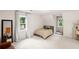Spacious bedroom with natural light and a simple bed and comfortable seating at 115 Leaf Lake Dr, Suwanee, GA 30024
