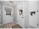 Entryway boasts brick floors and two doors with decorative shade coverings and hardware at 115 Leaf Lake Dr, Suwanee, GA 30024