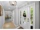 Bright foyer with hardwood floors, elegant lighting, and a view to the office at 115 Leaf Lake Dr, Suwanee, GA 30024