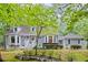 Charming two-story home with gray siding, manicured landscaping, and a welcoming front porch at 115 Leaf Lake Dr, Suwanee, GA 30024