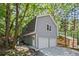 Detached two-car garage surrounded by trees at 115 Leaf Lake Dr, Suwanee, GA 30024
