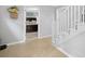Hallway with light wood floors and stairs leading to the upper level at 115 Leaf Lake Dr, Suwanee, GA 30024