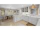 Bright, white kitchen featuring shaker cabinets, marble countertops, and modern appliances at 115 Leaf Lake Dr, Suwanee, GA 30024