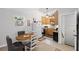 Charming kitchen area featuring white appliances, wooden cabinets, and dining table at 115 Leaf Lake Dr, Suwanee, GA 30024