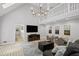 Upstairs living room featuring fireplace, living area, and view into a well-lit kitchen at 115 Leaf Lake Dr, Suwanee, GA 30024