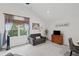 Bright living room with large windows, sofa, cabinet and gray chairs at 115 Leaf Lake Dr, Suwanee, GA 30024