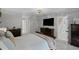 Comfortable main bedroom featuring a large bed, dresser, and television with a doorway to the main hall and staircase at 115 Leaf Lake Dr, Suwanee, GA 30024