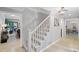 Elegant stairway featuring decorative stair risers, wooden steps, and white painted railings at 115 Leaf Lake Dr, Suwanee, GA 30024