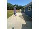 Concrete patio and an umbrella, adjacent to a lush green lawn at 160 Springdale Ct, Newborn, GA 30056