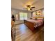 Spacious bedroom with natural light, wooden furniture, and a ceiling fan at 160 Springdale Ct, Newborn, GA 30056
