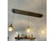 Three vintage hanging lights over a bar with liquor bottles and barware displayed at 160 Springdale Ct, Newborn, GA 30056