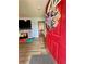 Bright entryway with red door and view into the dining area and living room at 160 Springdale Ct, Newborn, GA 30056