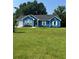 Inviting blue house with lush green lawn and an American flag proudly displayed at 160 Springdale Ct, Newborn, GA 30056