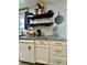 Close-up on a granite kitchen counter with white cabinets, shelves, and modern appliances at 160 Springdale Ct, Newborn, GA 30056