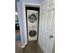 Convenient laundry closet showcasing a stacked washer and dryer unit at 160 Springdale Ct, Newborn, GA 30056