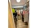 Organized walk-in closet with shelving, hanging clothes, and full length mirror at 160 Springdale Ct, Newborn, GA 30056