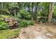 Stone patio with beautiful landscaping, waterfall and a charming bridge at 3699 Canyon Ridge Ne Ct, Brookhaven, GA 30319