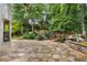 Stone patio with beautiful landscaping, waterfall and a charming bridge at 3699 Canyon Ridge Ne Ct, Brookhaven, GA 30319