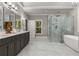 A bright bathroom offers dual sinks, a soaking tub, and a glass shower at 3699 Canyon Ridge Ne Ct, Brookhaven, GA 30319