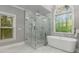 A luxurious bathroom features a glass enclosed shower, a chandelier, and a soaking tub at 3699 Canyon Ridge Ne Ct, Brookhaven, GA 30319
