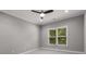 Bedroom featuring a ceiling fan, neutral walls, and a large window with blinds at 3699 Canyon Ridge Ne Ct, Brookhaven, GA 30319