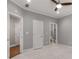 Bedroom with neutral carpet, grey walls, two doorways, and ceiling fan with light at 3699 Canyon Ridge Ne Ct, Brookhaven, GA 30319