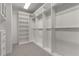A walk-in closet provides ample storage space with shelving, drawers, and hanging rods at 3699 Canyon Ridge Ne Ct, Brookhaven, GA 30319