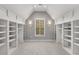 Bright, walk-in closet with custom shelving and a window providing natural light at 3699 Canyon Ridge Ne Ct, Brookhaven, GA 30319