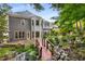Back exterior of house with lush garden, pond and small bridge at 3699 Canyon Ridge Ne Ct, Brookhaven, GA 30319