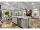 Open-concept kitchen with island, granite countertops, stainless steel appliances, and stone tile flooring at 3699 Canyon Ridge Ne Ct, Brookhaven, GA 30319