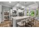 Stunning kitchen features a large island with seating, stainless steel appliances, and beautiful stone floors at 3699 Canyon Ridge Ne Ct, Brookhaven, GA 30319