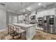 Bright kitchen showcasing granite countertops, stainless appliances, large island with seating, and stone tile flooring at 3699 Canyon Ridge Ne Ct, Brookhaven, GA 30319